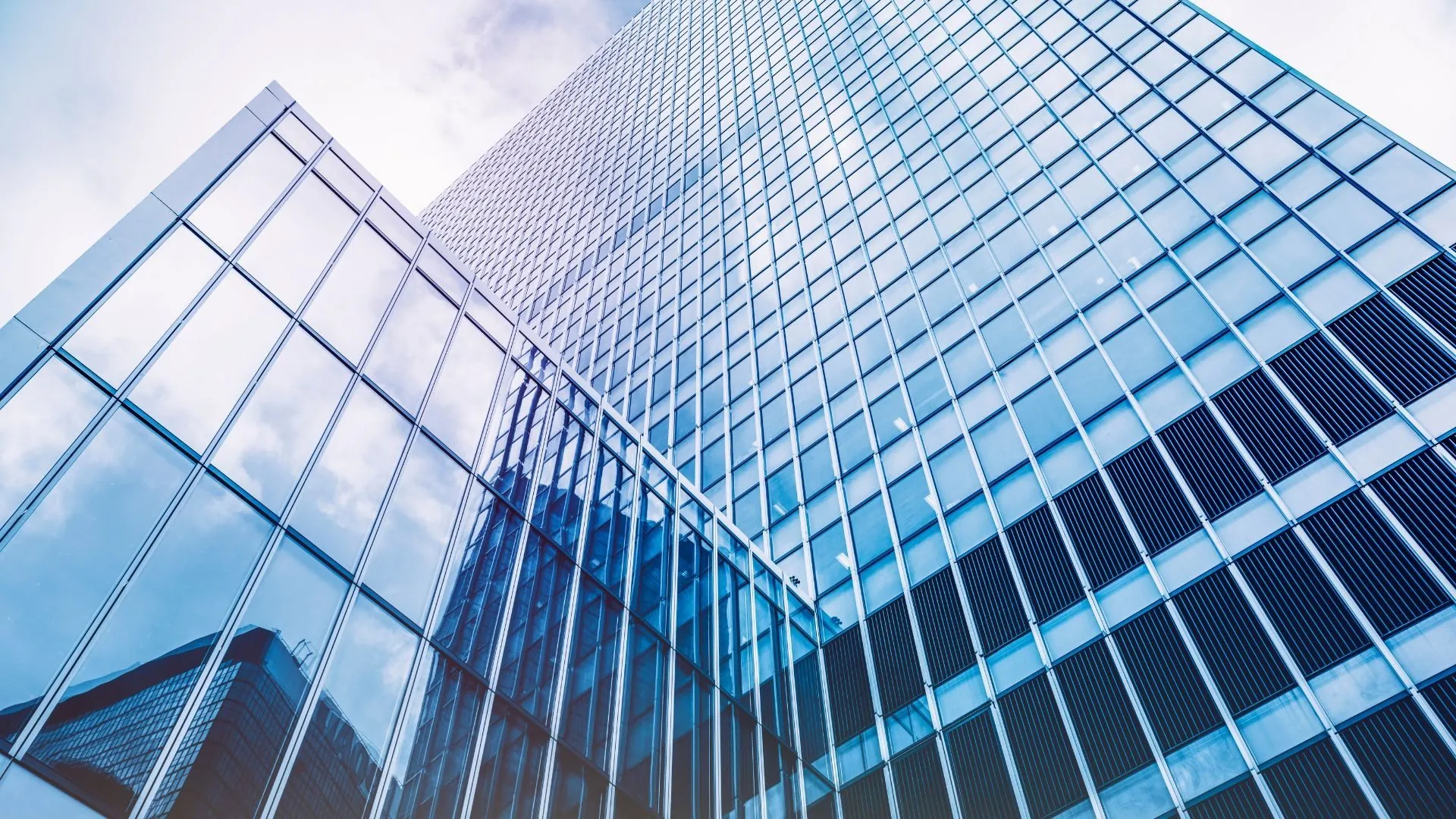Dramatic upward view of multiple glass towers