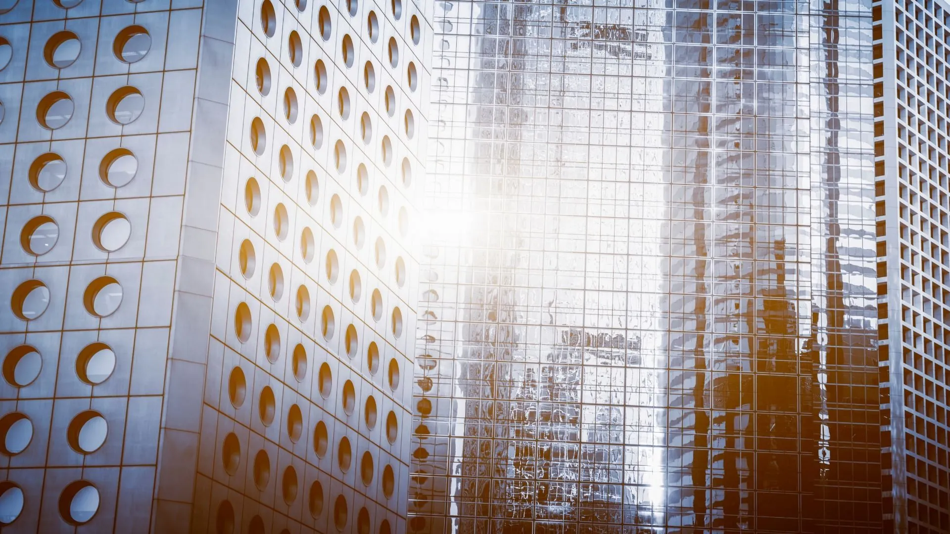 Sunlit building facade with circular window details