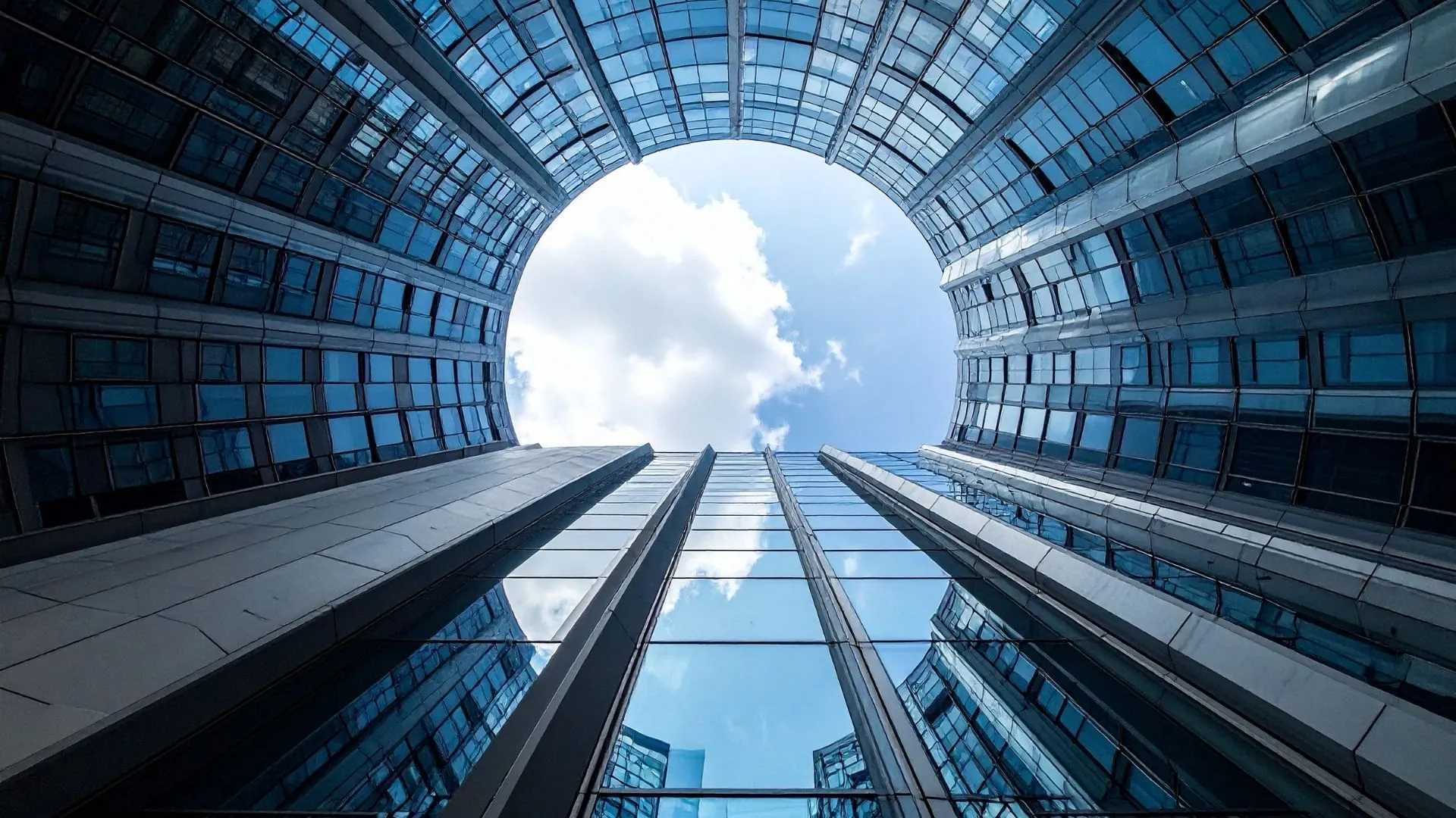 Curved glass building atrium opening to the sky