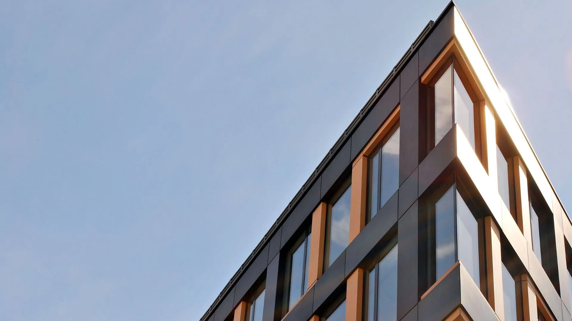 Sunlit building facade with warm copper tones